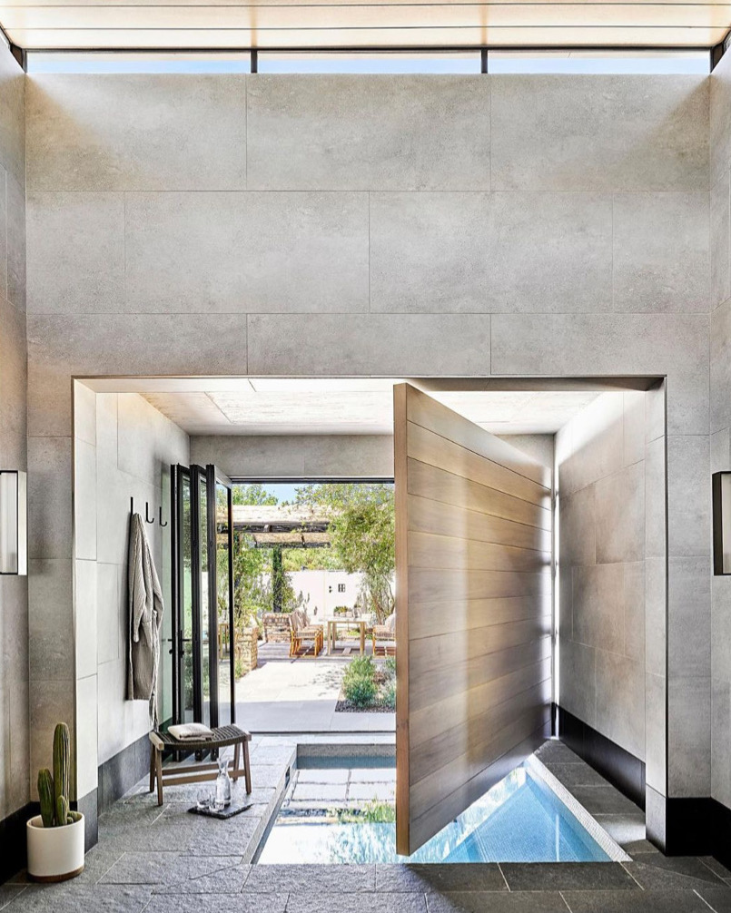 Large modern wood door opened to reveal indoor pool.