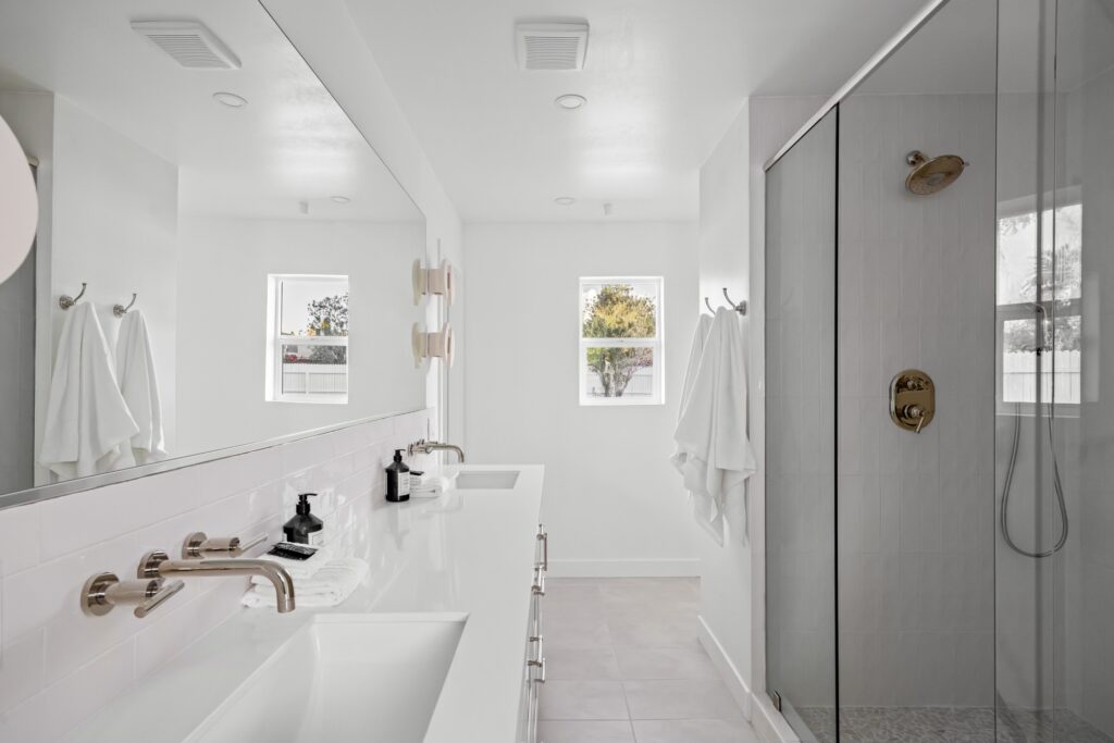 Renovated bathroom with walk-in shower, updated tile, and sleek vanity design.