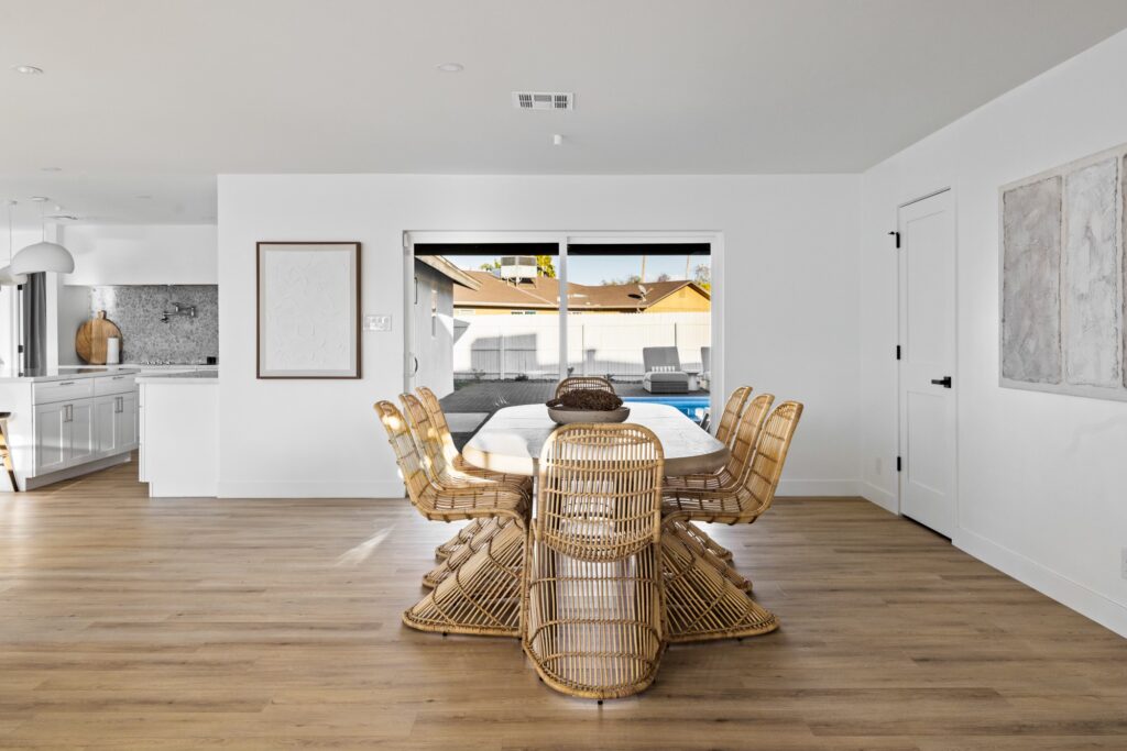 Modern renovated living room with open layout, large windows, and contemporary furnishings