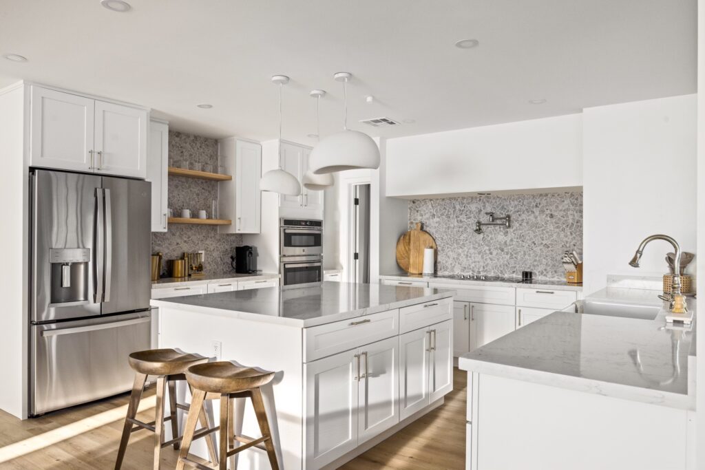 Remodeled kitchen with modern cabinetry, quartz countertops, and stainless steel appliances.