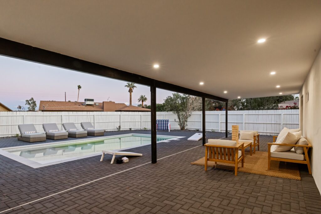 Stylish covered patio with ceiling fan and outdoor seating, perfect for year-round entertaining in the Phoenix climate.