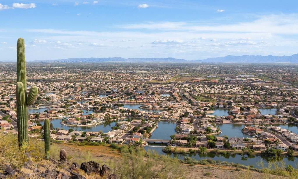 Aerial view of Glendale, Arizona showcasing city buildings, roads, and surrounding desert landscape under a clear sky.