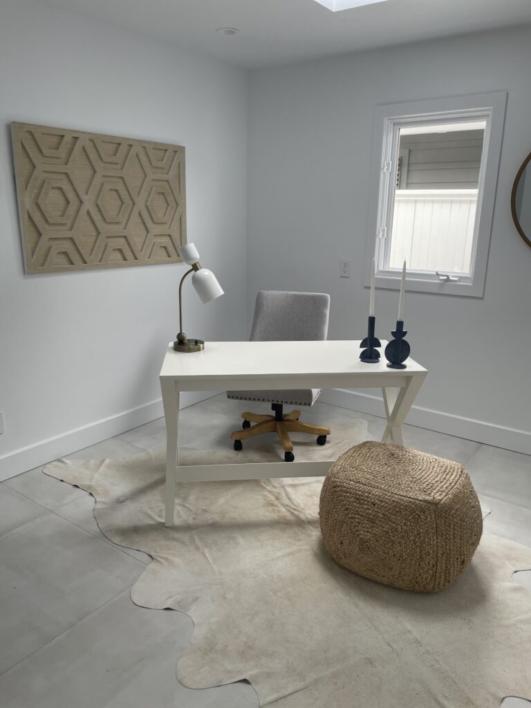 Custom-built home office with large windows and modern shelving, designed for remote work in a Phoenix luxury home.